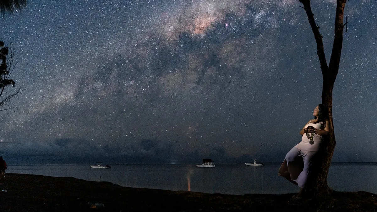 woman-posing-beside-tree-under-milky-way.jpg